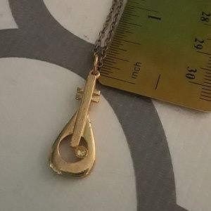 Brand new guitar with jewel necklace